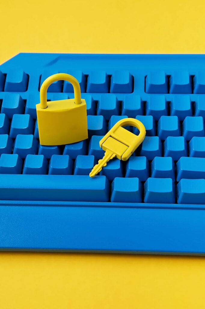 Cyber data and information security idea. Yellow padlock and key and blue keyboard. Computer